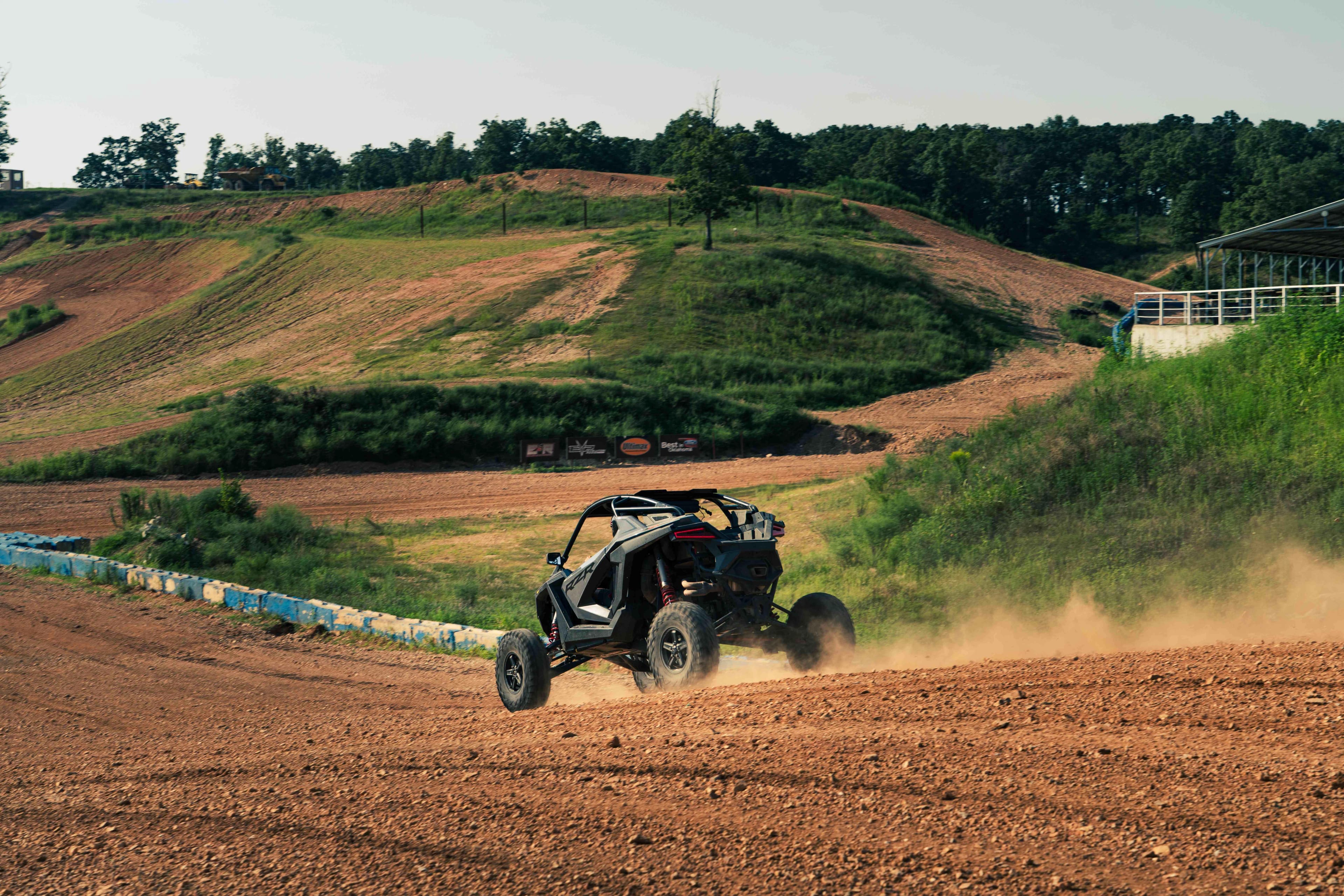 Side-by-side vehicle drifting on dirt
